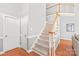 Inviting staircase with carpeted steps and wood railing leading to the upper level at 7925 Tottenham Dr, Harrisburg, NC 28075