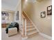 Inviting basement with carpeted stairs and walls adorned with photographs, next to bonus room at 8416 Highgrove St, Charlotte, NC 28277