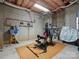 Basement space equipped with exercise equipment and unfinished walls, ready to be converted to your needs at 8416 Highgrove St, Charlotte, NC 28277