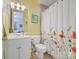 Cozy bathroom with floral shower curtain, vanity, and matching fixtures at 8416 Highgrove St, Charlotte, NC 28277