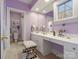 A stylish bathroom with a vanity, make up counter, a stool, and a window providing natural light at 8416 Highgrove St, Charlotte, NC 28277