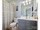 Classic bathroom featuring a shower/tub combo and gray vanity with neutral walls and floors at 8416 Highgrove St, Charlotte, NC 28277