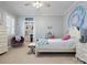 A serene bedroom featuring a white bed frame, soft colors, and a whimsical decor, complemented by a built-in desk at 8416 Highgrove St, Charlotte, NC 28277