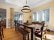 Bright dining area featuring a rustic table and modern lighting, with a view of outdoor patio at 8416 Highgrove St, Charlotte, NC 28277