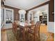 Elegant dining room featuring hardwood floors, a chandelier, and a view into the living room fireplace at 8416 Highgrove St, Charlotte, NC 28277