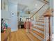 Bright foyer featuring hardwood floors, a staircase with white spindles, and views into the living spaces at 8416 Highgrove St, Charlotte, NC 28277