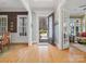 Bright and airy foyer with hardwood floors, detailed trim, and an open doorway with views to the front yard at 8416 Highgrove St, Charlotte, NC 28277