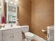 Convenient half-bathroom with eye catching wallpaper and neutral-colored tiles at 8416 Highgrove St, Charlotte, NC 28277