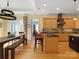 Spacious kitchen with wooden cabinets, a large island, granite countertops, and an adjacent dining area at 8416 Highgrove St, Charlotte, NC 28277