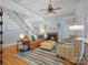 Comfortable living room with a fireplace, staircase, tray ceilings and a cozy seating arrangement at 8416 Highgrove St, Charlotte, NC 28277