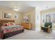 Bright main bedroom with a ceiling fan, neutral walls and a comfortable seating area by the window at 8416 Highgrove St, Charlotte, NC 28277