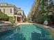Spacious backyard featuring a large pool, stone patio, and spiral staircase at 8416 Highgrove St, Charlotte, NC 28277