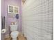 Bathroom with a toilet and a shower with white and black striped shower curtain at 8416 Highgrove St, Charlotte, NC 28277