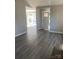 Inviting living room with new flooring, a brick fireplace, and an abundance of natural light at 8515 Mission Hills Rd, Charlotte, NC 28227