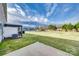 Scenic backyard features a patio, pergola, lush lawn, and water views at 876 Summerlake Dr, Fort Mill, SC 29715