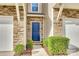 Inviting entrance with a blue front door, stone accents, manicured bushes, and a well-lit walkway at 876 Summerlake Dr, Fort Mill, SC 29715