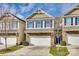 Charming two-story home showcasing a stone facade, a white garage door, and blue shutters, creating a welcoming curb appeal at 876 Summerlake Dr, Fort Mill, SC 29715