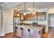 Modern kitchen featuring stainless steel appliances, granite countertops, a kitchen island, and dark wood cabinets at 876 Summerlake Dr, Fort Mill, SC 29715