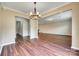 Spacious living room featuring beautiful wood floors and a decorative chandelier at 876 Summerlake Dr, Fort Mill, SC 29715