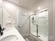 Bright bathroom featuring a glass enclosed shower and double sink vanity at 9025 Remnick Dr, Gastonia, NC 28056