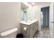 Bathroom featuring double sinks, tile floor, white walls, and a bright airy feel at 9025 Remnick Dr, Gastonia, NC 28056