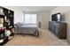 Cozy bedroom with neutral carpet, closet, and a sunny window providing natural light at 9025 Remnick Dr, Gastonia, NC 28056