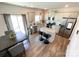 Well-lit kitchen with stainless steel appliances, an island, and an adjacent dining area at 9025 Remnick Dr, Gastonia, NC 28056