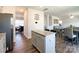Open kitchen features an island with granite countertops and stainless steel appliances at 9025 Remnick Dr, Gastonia, NC 28056