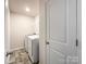 Laundry room featuring tile flooring, white walls, and modern washer and dryer at 9025 Remnick Dr, Gastonia, NC 28056