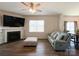Cozy living room with a fireplace, ceiling fan and comfortable seating at 9025 Remnick Dr, Gastonia, NC 28056