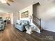 Comfortable living room with hardwood floors, stairway to second floor, open to kitchen at 9025 Remnick Dr, Gastonia, NC 28056