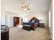 Spacious main bedroom featuring a decorative ceiling fan, a king bed, and an attached bath at 9025 Remnick Dr, Gastonia, NC 28056