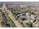 An aerial view shows apartment buildings with ample parking, surrounded by trees and a road running alongside them at 9405 Old Concord Rd # G, Charlotte, NC 28213