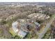 Aerial view of a complex surrounded by trees, parking and roads, showcasing its scenic location and convenience at 9405 Old Concord Rd # G, Charlotte, NC 28213