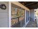 Cozy outdoor balcony featuring a sliding glass door entry with outdoor lighting fixture at 9405 Old Concord Rd # G, Charlotte, NC 28213