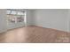 Bright bedroom with a large window and light colored wood flooring at 9405 Old Concord Rd # G, Charlotte, NC 28213