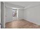 Bright bedroom featuring hardwood floors, a large window and neutral walls, ideal for versatile décor options at 9405 Old Concord Rd # G, Charlotte, NC 28213