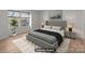 Staged bedroom featuring modern furniture and a bright window with wood floors at 9405 Old Concord Rd # G, Charlotte, NC 28213