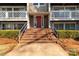 Inviting entryway with brick steps that lead to a vibrant red door and well-maintained landscaping at 9405 Old Concord Rd # G, Charlotte, NC 28213