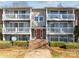 Attractive condo building with a red front door and private balconies perfect for relaxing outdoors at 9405 Old Concord Rd # G, Charlotte, NC 28213