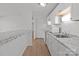 Galley kitchen with breakfast bar, white cabinets and subway tile backsplash at 9405 Old Concord Rd # G, Charlotte, NC 28213