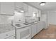 Bright kitchen features white cabinets, subway tile, and stainless oven and microwave at 9405 Old Concord Rd # G, Charlotte, NC 28213