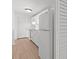 Bright kitchen features white appliances, cabinets, and countertop with wood floor at 9405 Old Concord Rd # G, Charlotte, NC 28213