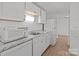 Traditional kitchen featuring white cabinets, granite countertops, stainless microwave and tile backsplash at 9405 Old Concord Rd # G, Charlotte, NC 28213