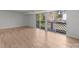 Bright living room featuring wood-look floors and sliding glass doors to a balcony at 9405 Old Concord Rd # G, Charlotte, NC 28213
