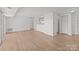Open living area with wood-look floors and sliding glass doors with a view of the kitchen and storage at 9405 Old Concord Rd # G, Charlotte, NC 28213