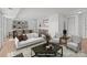 Bright, staged living room features wood-look floors, neutral paint, view to kitchen and dining area at 9405 Old Concord Rd # G, Charlotte, NC 28213