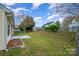 Spacious backyard featuring green grass, a wood fence and mature trees at 10130 Illoria Dr, Charlotte, NC 28273