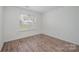 Bedroom offering a large window, hardwood floors, and a neutral wall color at 10130 Illoria Dr, Charlotte, NC 28273