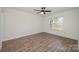 Bright bedroom features a ceiling fan, window views, and hardwood floors at 10130 Illoria Dr, Charlotte, NC 28273
